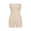 SEAMLESS SCULPT STRAPLESS SHORTIE BODYSUIT | SAND