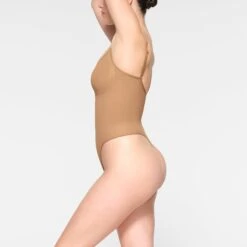 SEAMLESS SCULPT THONG BODYSUIT | OCHRE -SWIMwear Sale Store SKIMS SHAPEWEAR BD THG 3369 IE OCH 0011 SD 76a2fe87 3ad9 451e b0be f0ff72044119